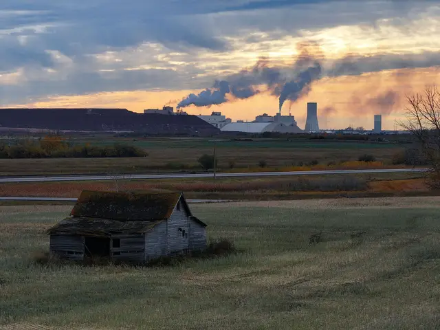 Abandoned farmhouse with potash mine at sunset